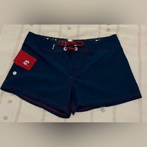Wave of life Juniors blue and red board shorts. Size large.